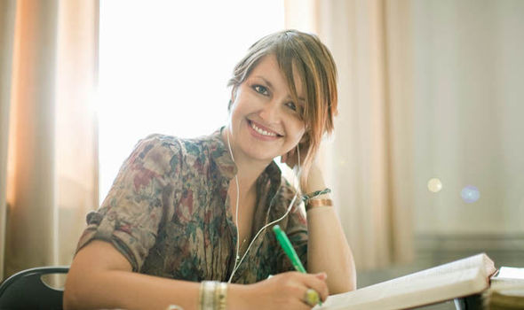 Woman writing on laptop